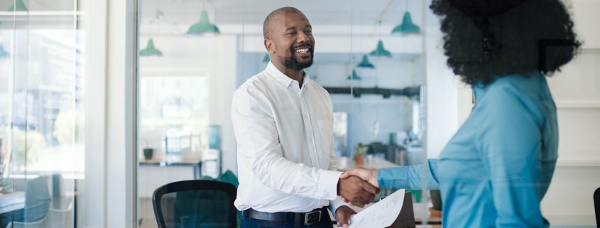 Image of two business people shaking hands.