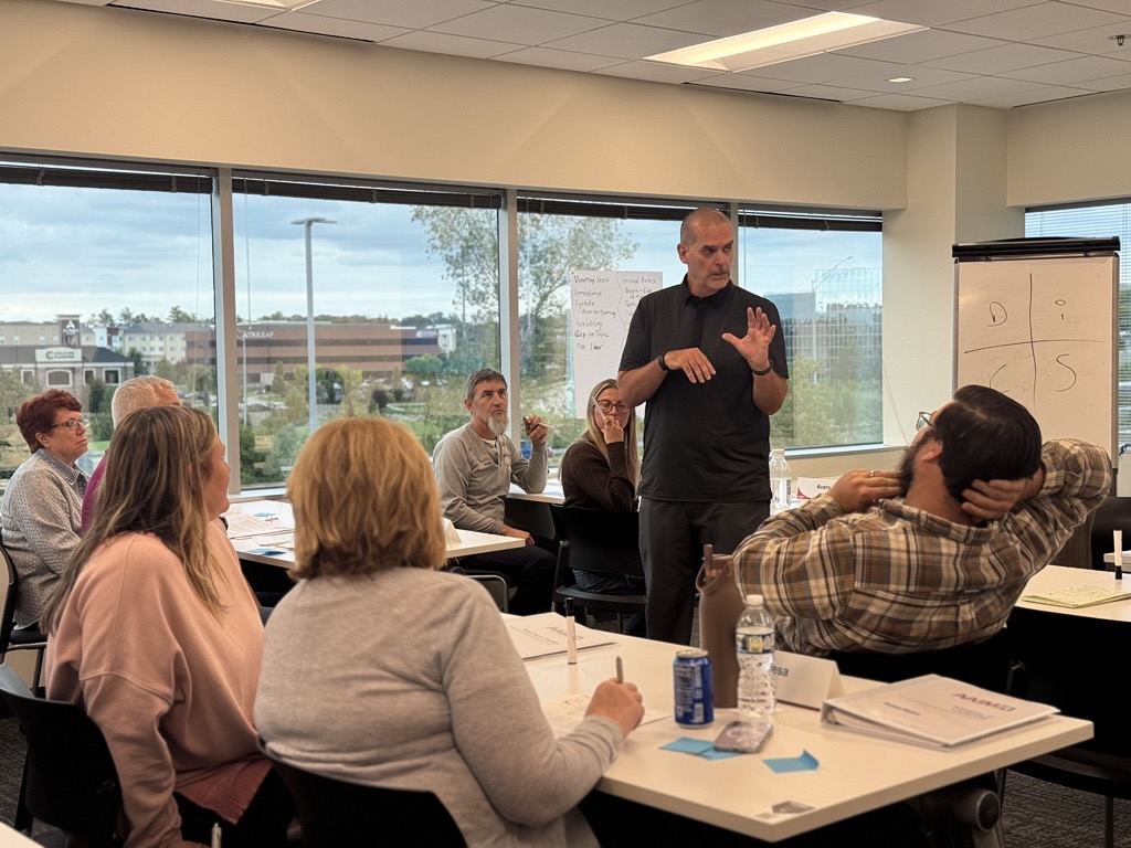 An AAIM facilitator leading a small-group training session